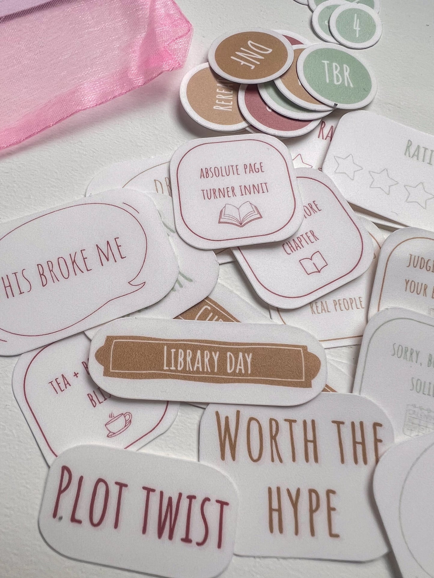 Collection of book-themed stickers on a light background